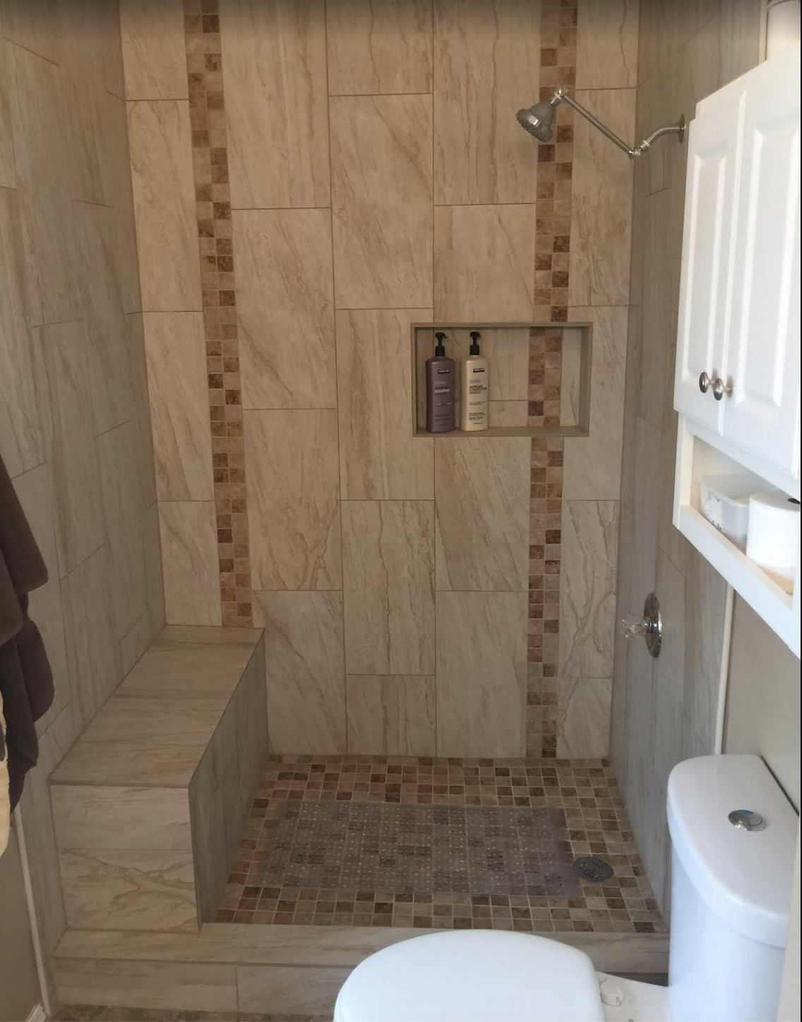 Fully tiled walk-in shower with niche and bench by Tile By Nic in Tucson, AZ