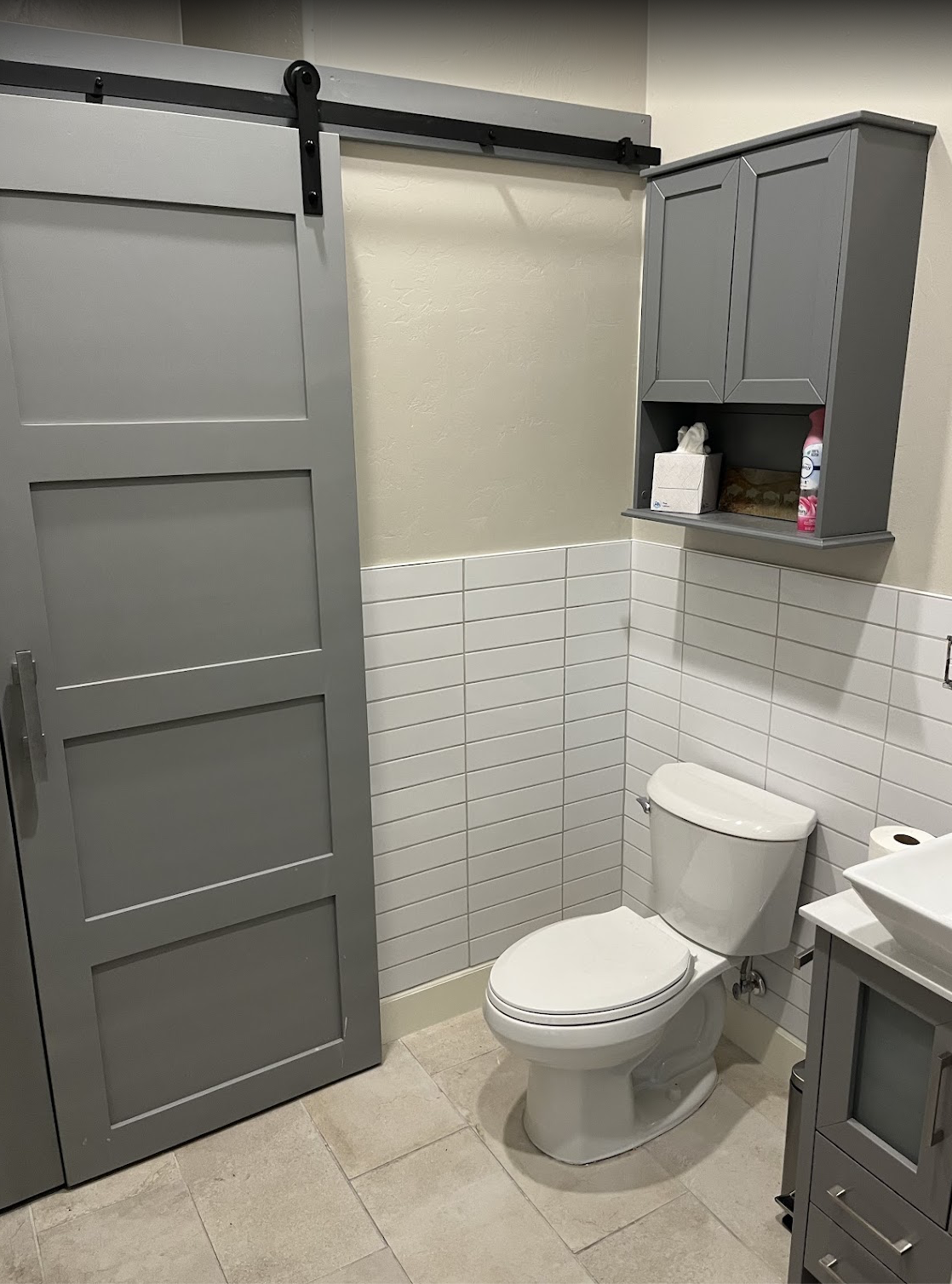 Bathroom with tile wainscoting and barn door